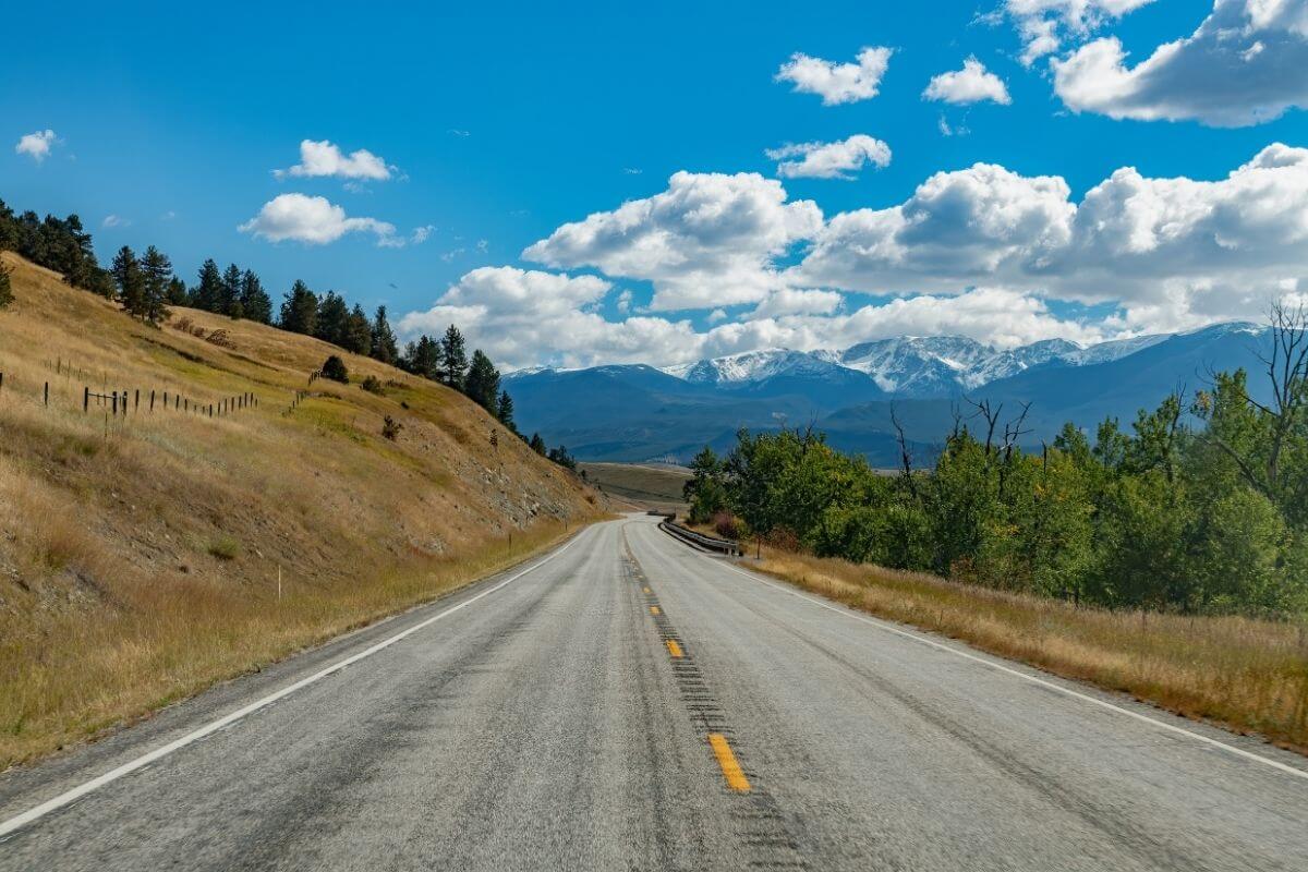 A road stretching through the mountains of Montana.