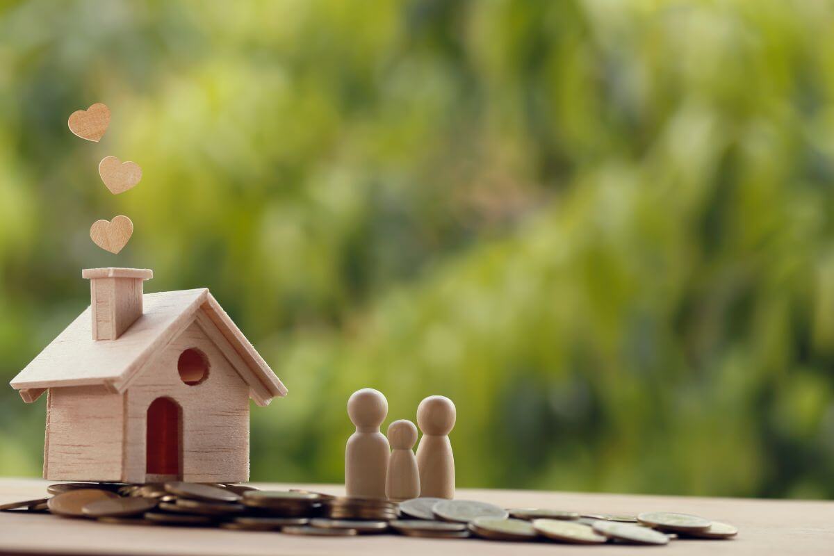 Money in Front of a Family Figurine with a House