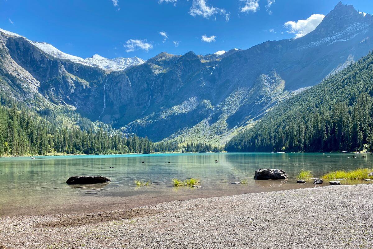 Avalanche Lake with trees and mountains in the background.