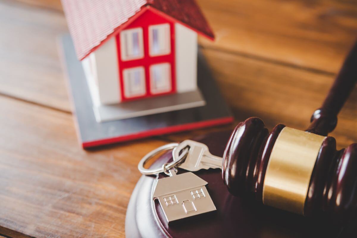 Small Red and White Model House with Keys and Gavel