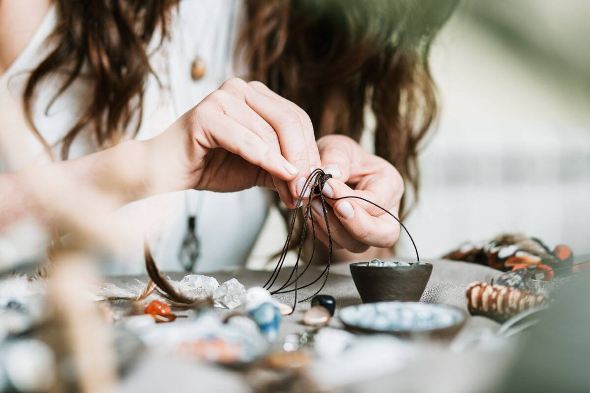 A woman is working on a piece of jewelry using Montana gemstones.