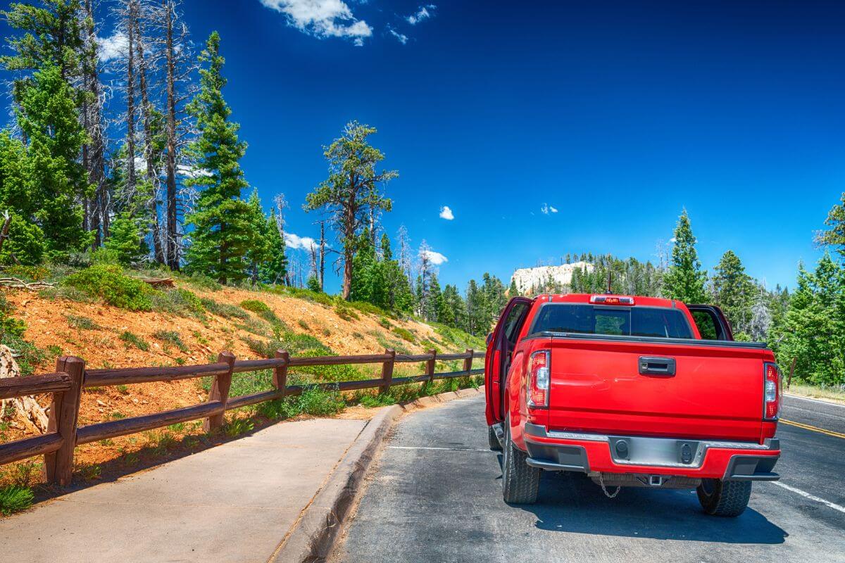 Red Car in the Middle of a Road in Montana