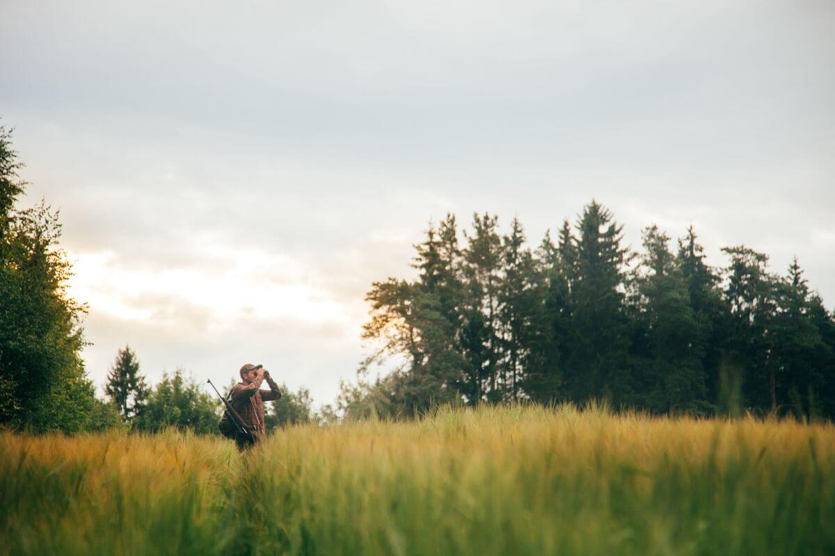 
A hunter in Montana scopes out the field using binoculars for any potential prey.