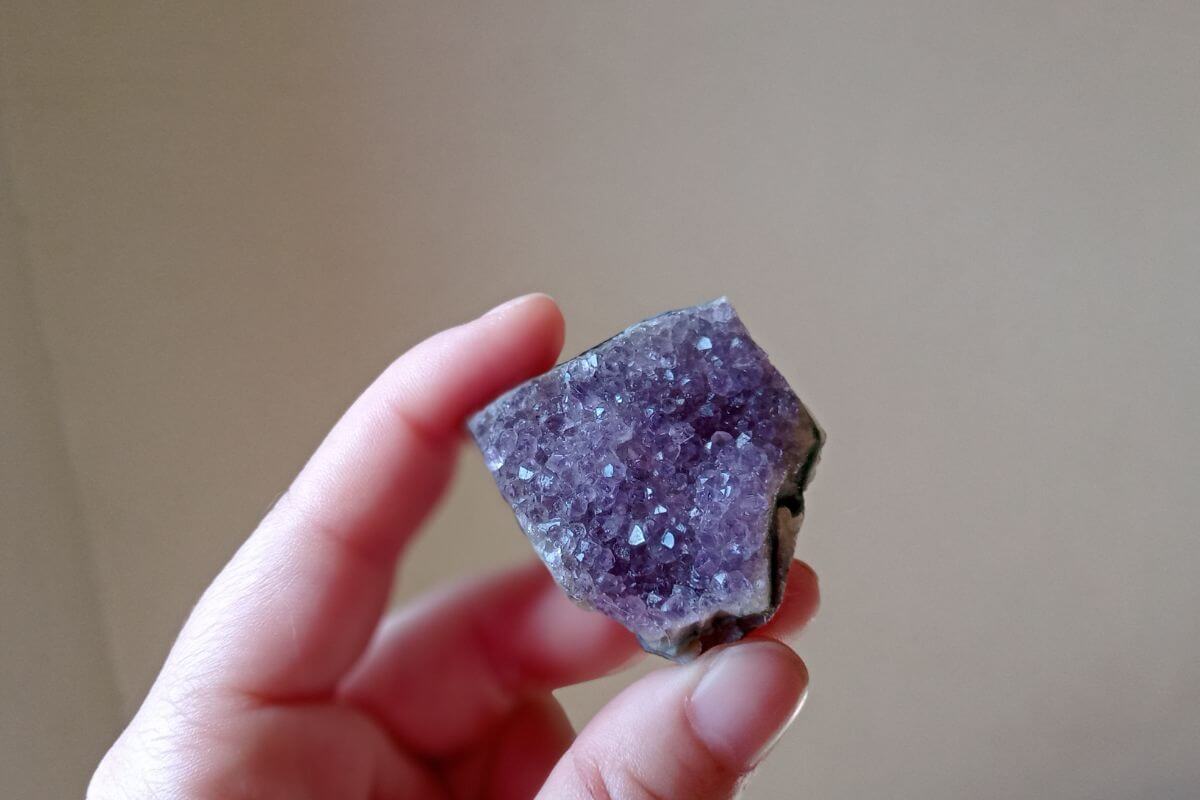 A person holding a piece of Montana amethyst.