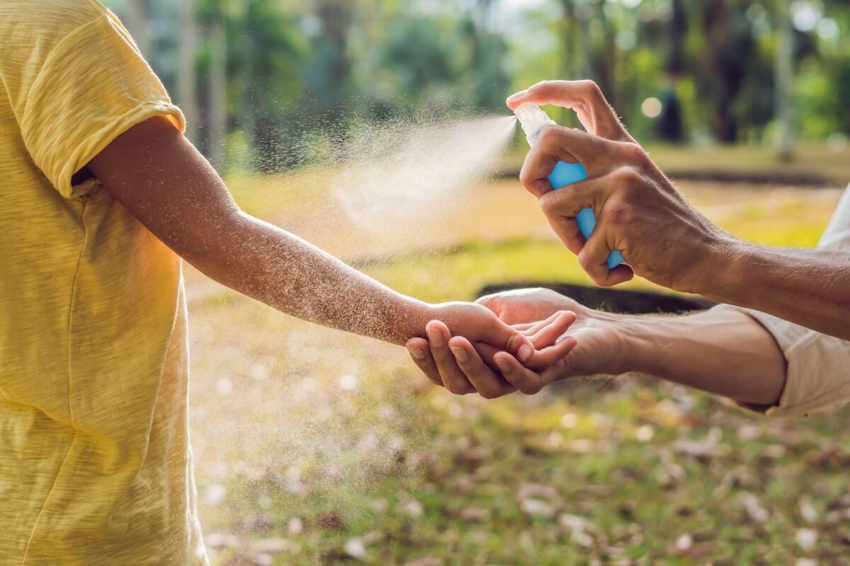 A man is spraying a child's hand with a sprayer in Montana.