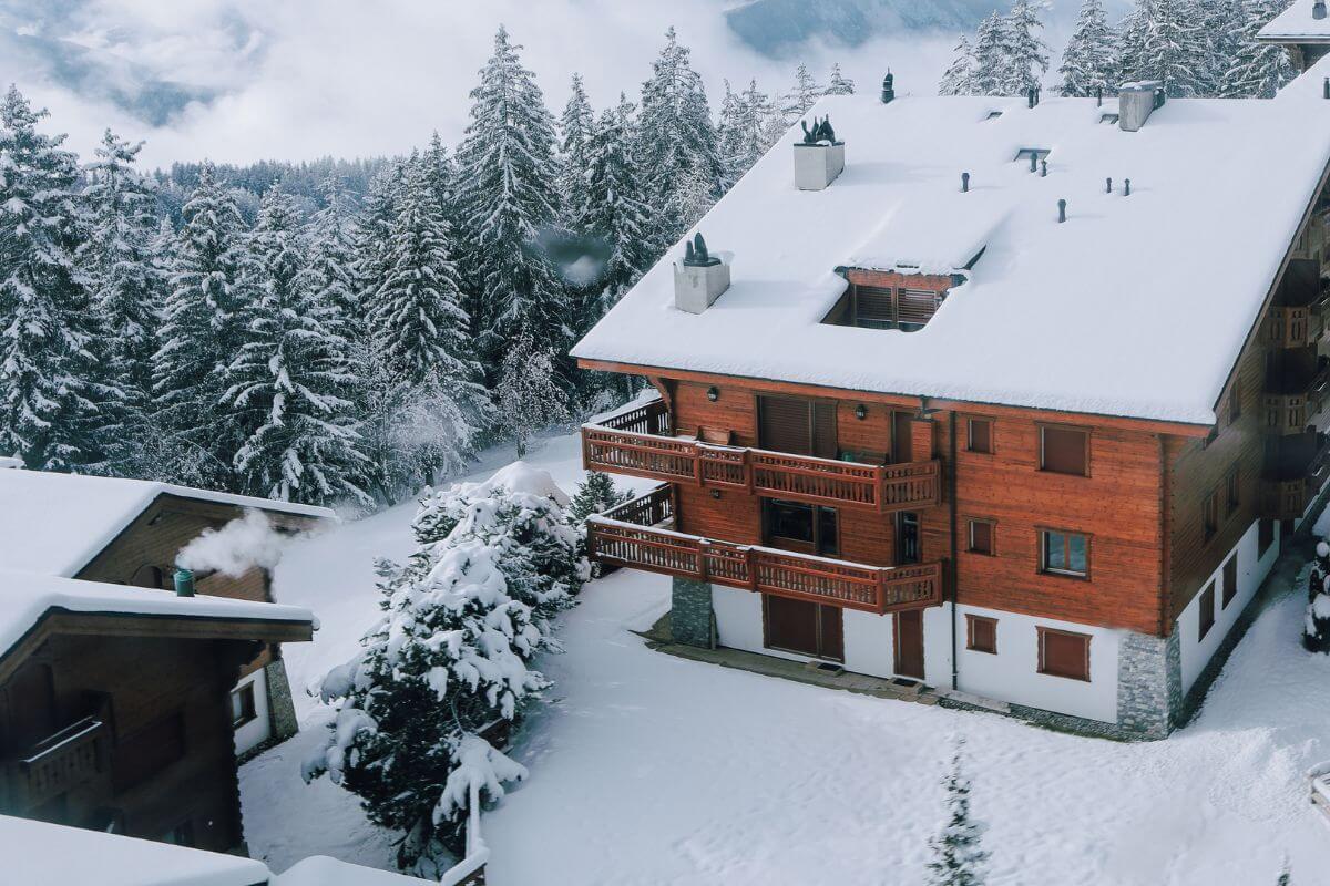 An aerial view of a wooden house in the snow in Montana.