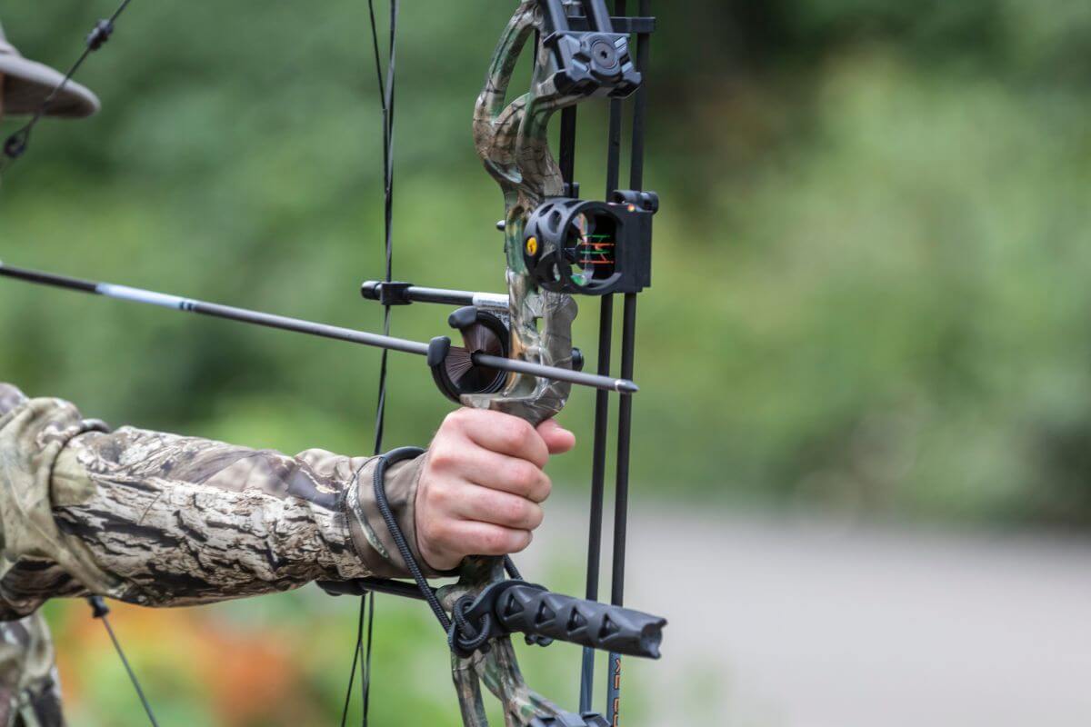 A hunter in Montana takes aim using the bow and arrow hunting techniques