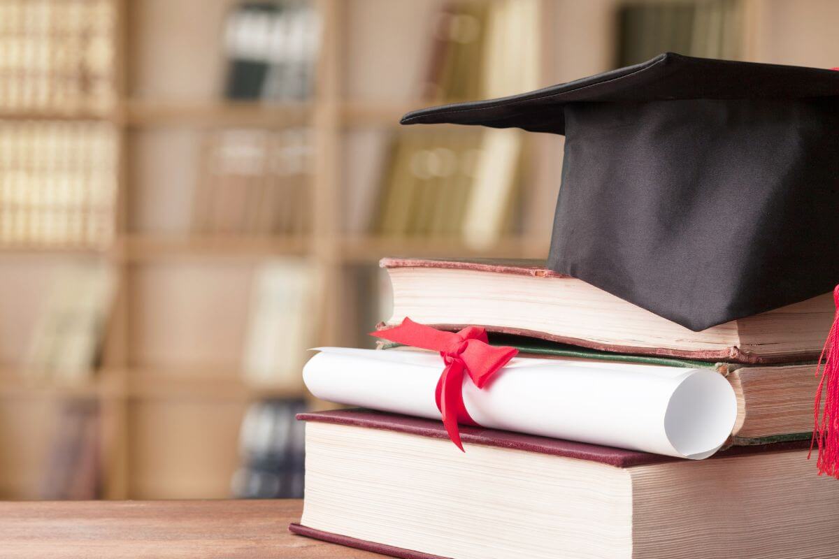 Table with Books, Dimploma, and Graduation Cap